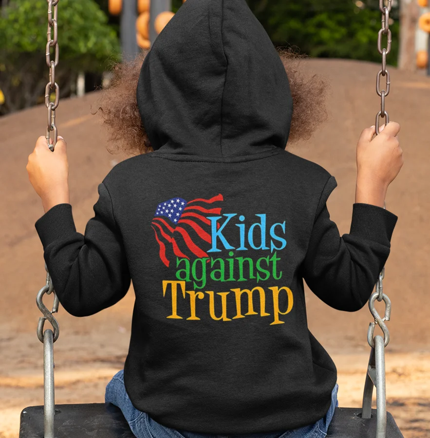 model wearing black hoodie with anti-trump design