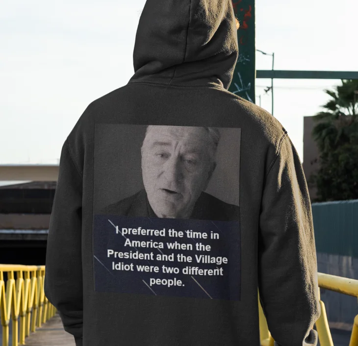 model wearing black hoodie with anti-trump design