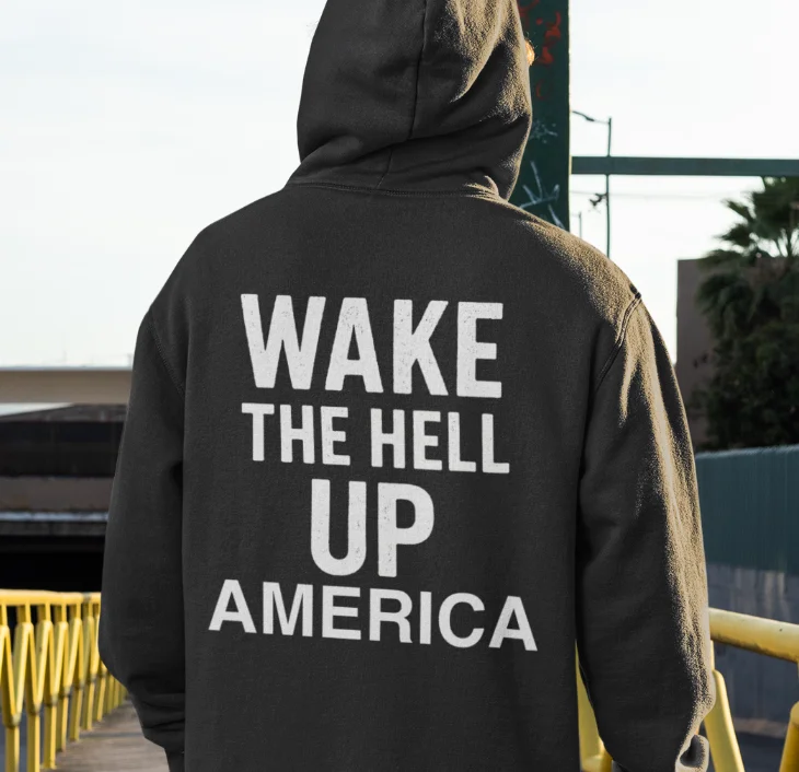 model wearing black hoodie with anti-trump design