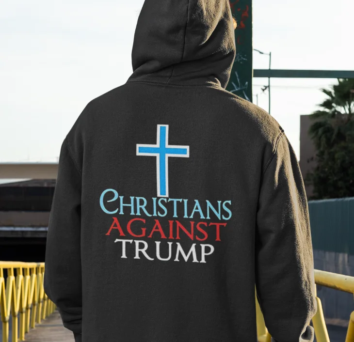 model wearing black hoodie with anti-trump design