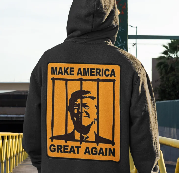 model wearing black hoodie with anti-trump design