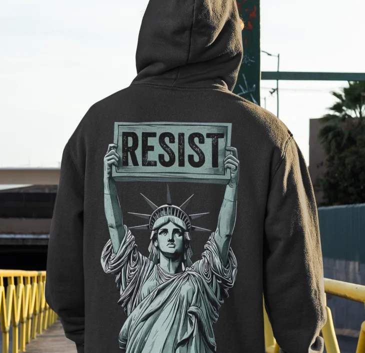model wearing black hoodie with anti-trump design