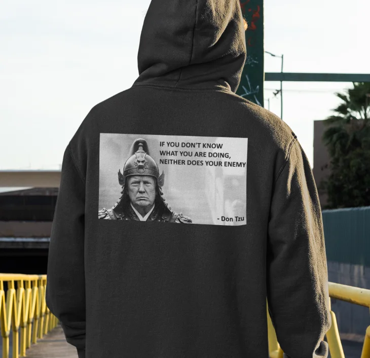 model wearing black hoodie with anti-trump design