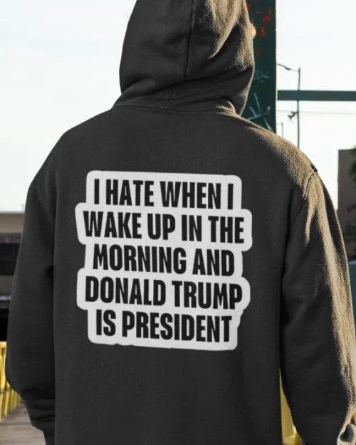 model wearing black hoodie with anti-trump design