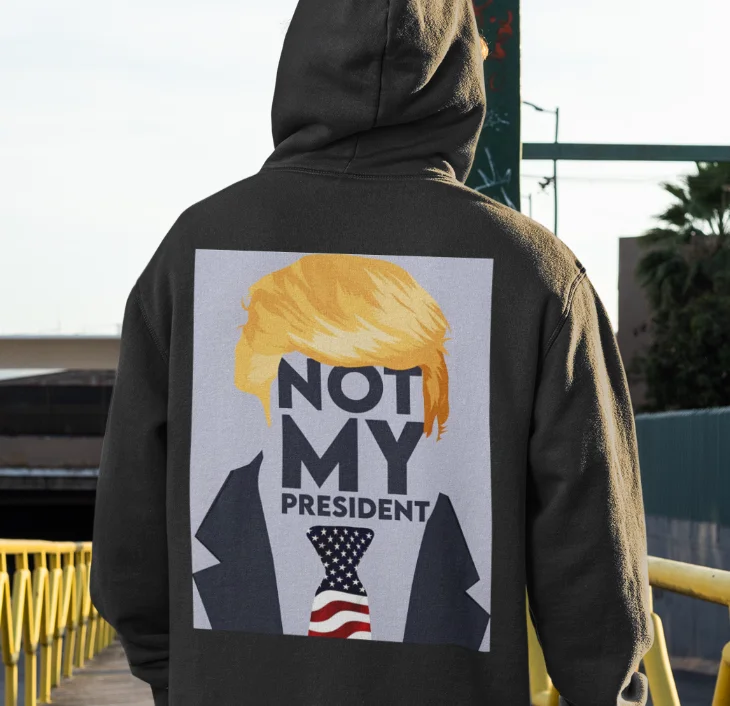 model wearing black hoodie with anti-trump design