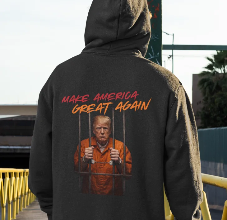 model wearing black hoodie with anti-trump design